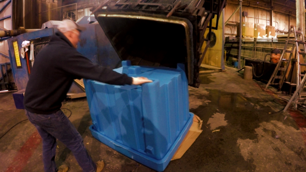 Rotationally molded product being pulled from mold